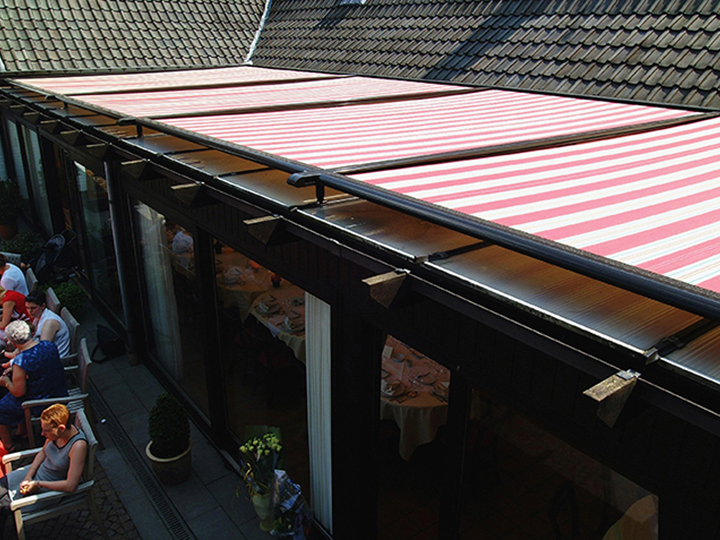 view from above of a coral and white striped conservatory awning